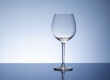 an empty wine glass sits on a table