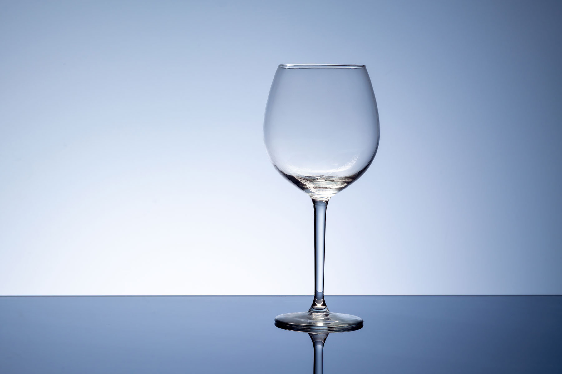 an empty wine glass sits on a table