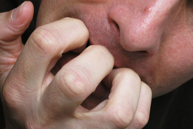 a person bites their nails wondering about what are self destructive behaviors