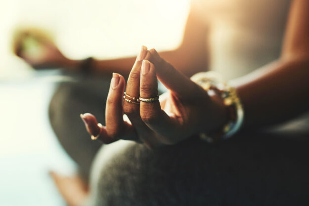 a woman practices yoga and meditation for holistic addiction recovery