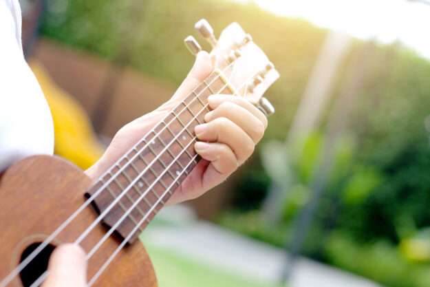 someone plays guitar to show the types of music therapy