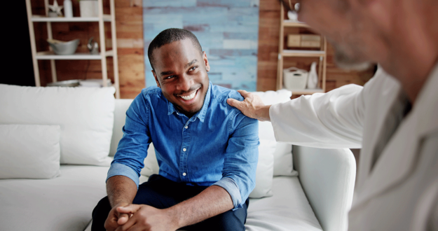 a man is encouraged by his therapist after a session