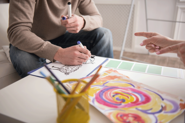 an art therapy participant works on a creative project